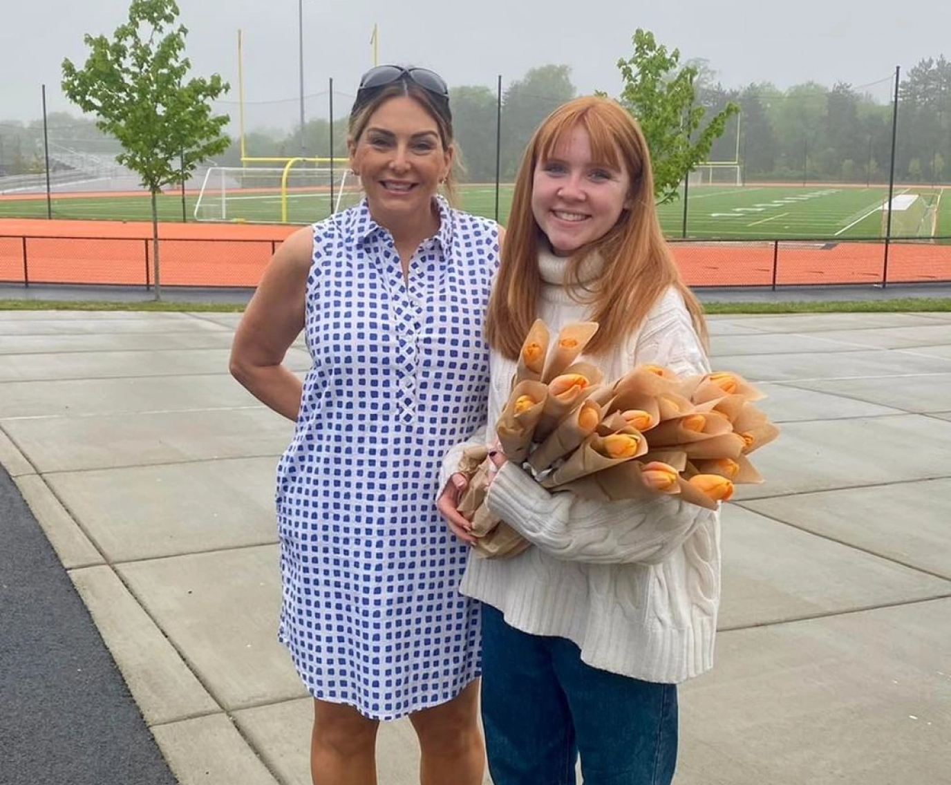 Catherine McGonagle, STEMS Co-Founder & President, holding orange tulips